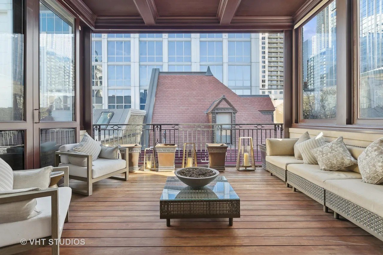 A three-seasons porch/balcony has an interesting view reflecting the Chicago Gold Coast of today.