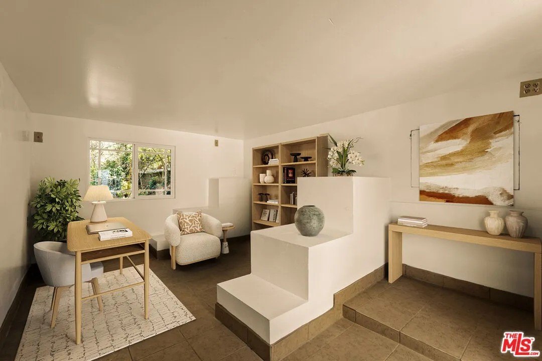 The other bedroom has been transformed into a modern, yet relaxing office with plenty of natural light steaming in through the window.