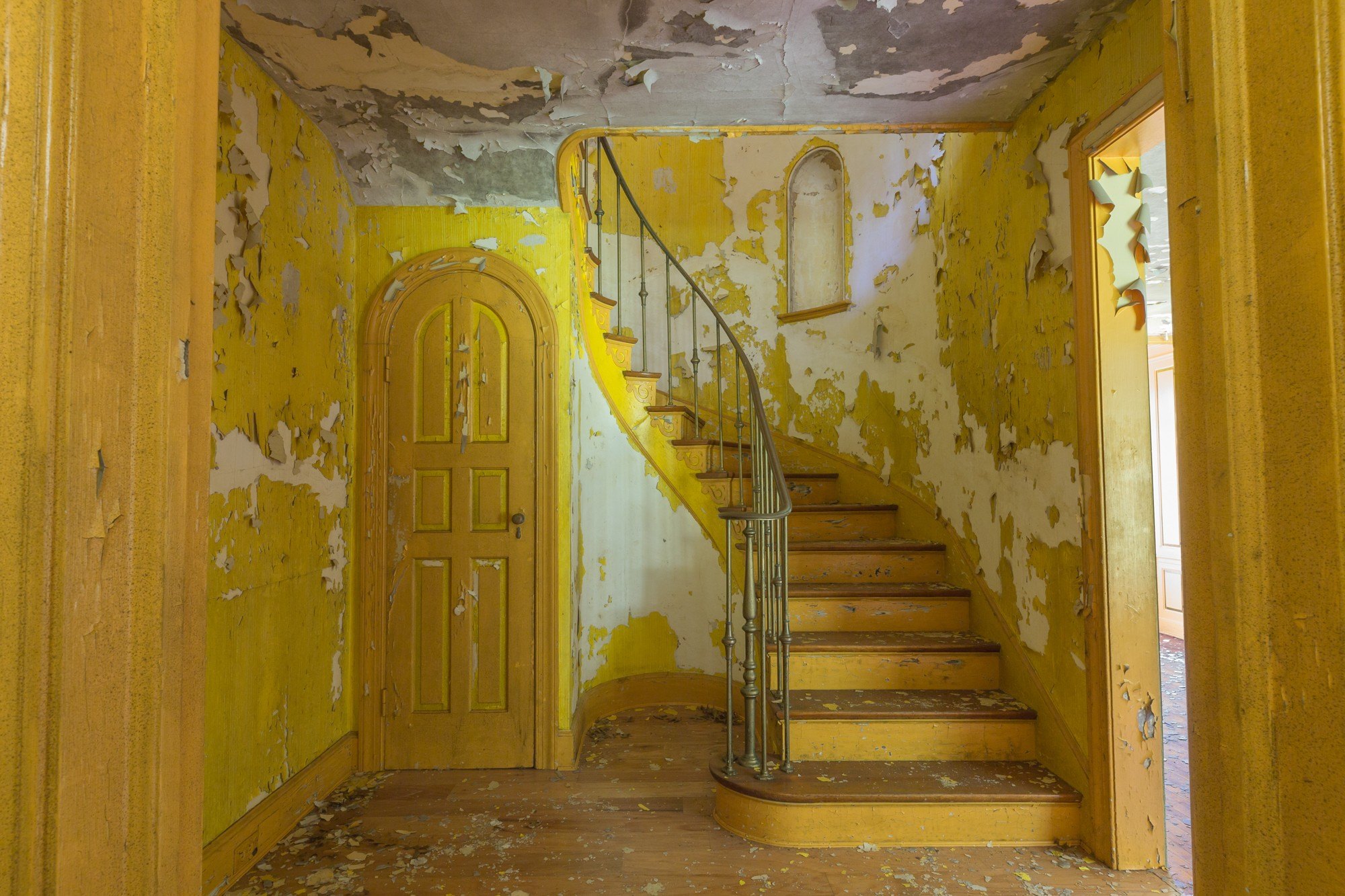 An abandoned circus themed house in New York with yellow stairs and walls