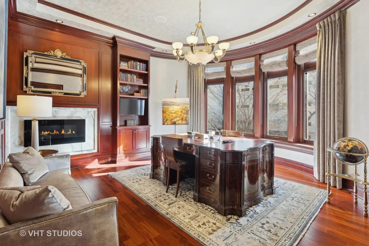 There are five fireplaces in the home, including this one in the bay windowed office.