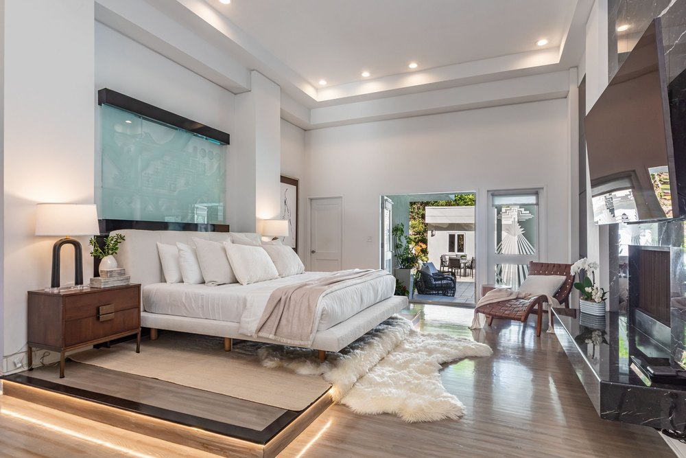 Bedroom with a fireplace in the Designer of Kate Hudson's 'How to Lose a Guy in 10 Days' Yellow Dress Home