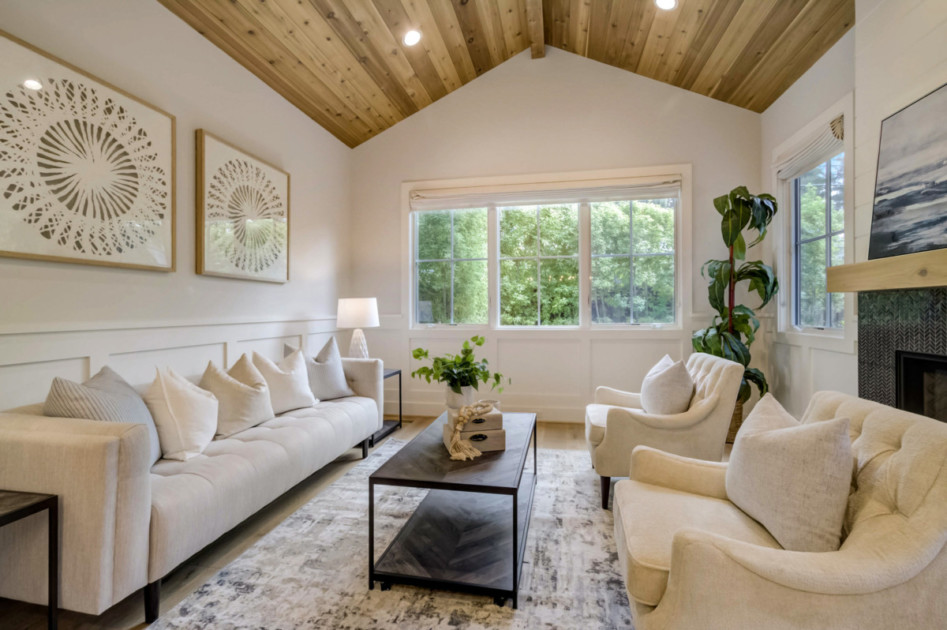 Living room with ivory furniture and a fireplace