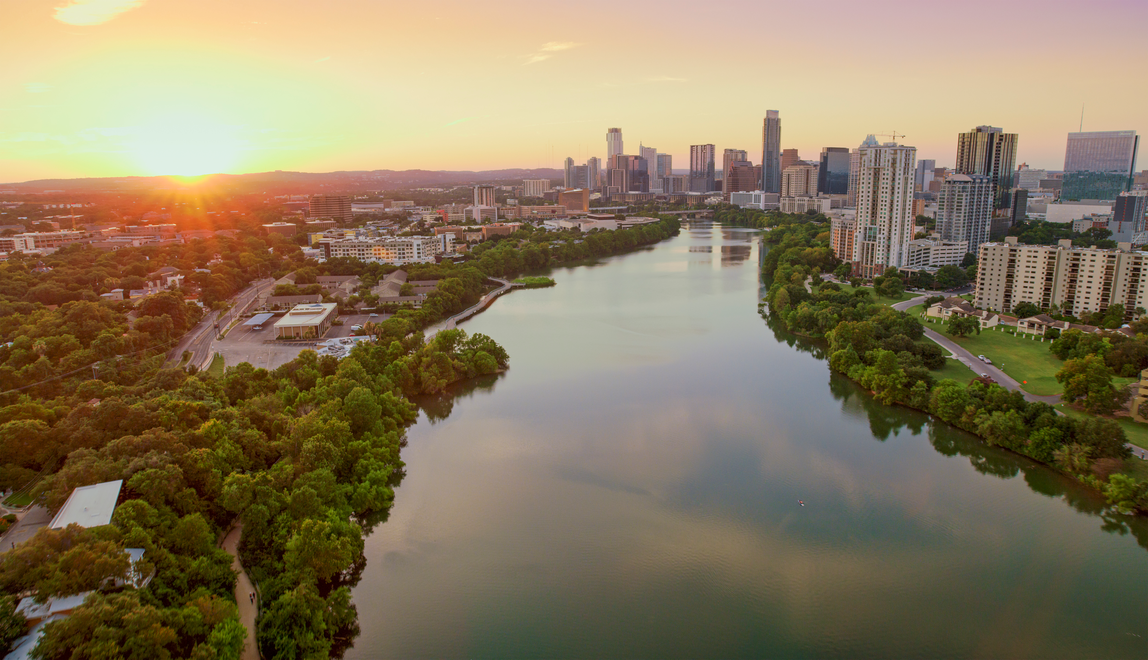 Colorado river passing through tree covered downtown Austin, Texas