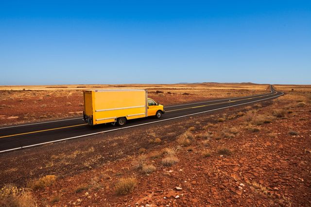 A moving van drives through the desert in Arizona.
