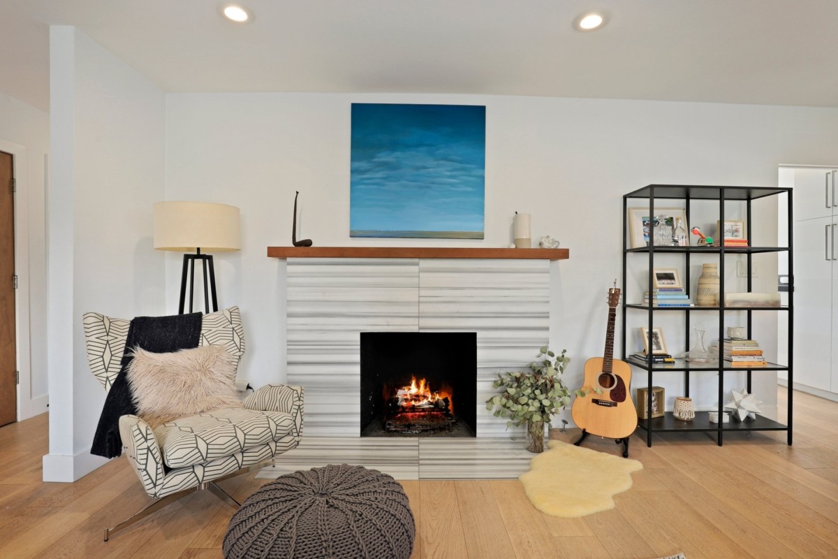 room with light colored walls minimal furniture and light sconces