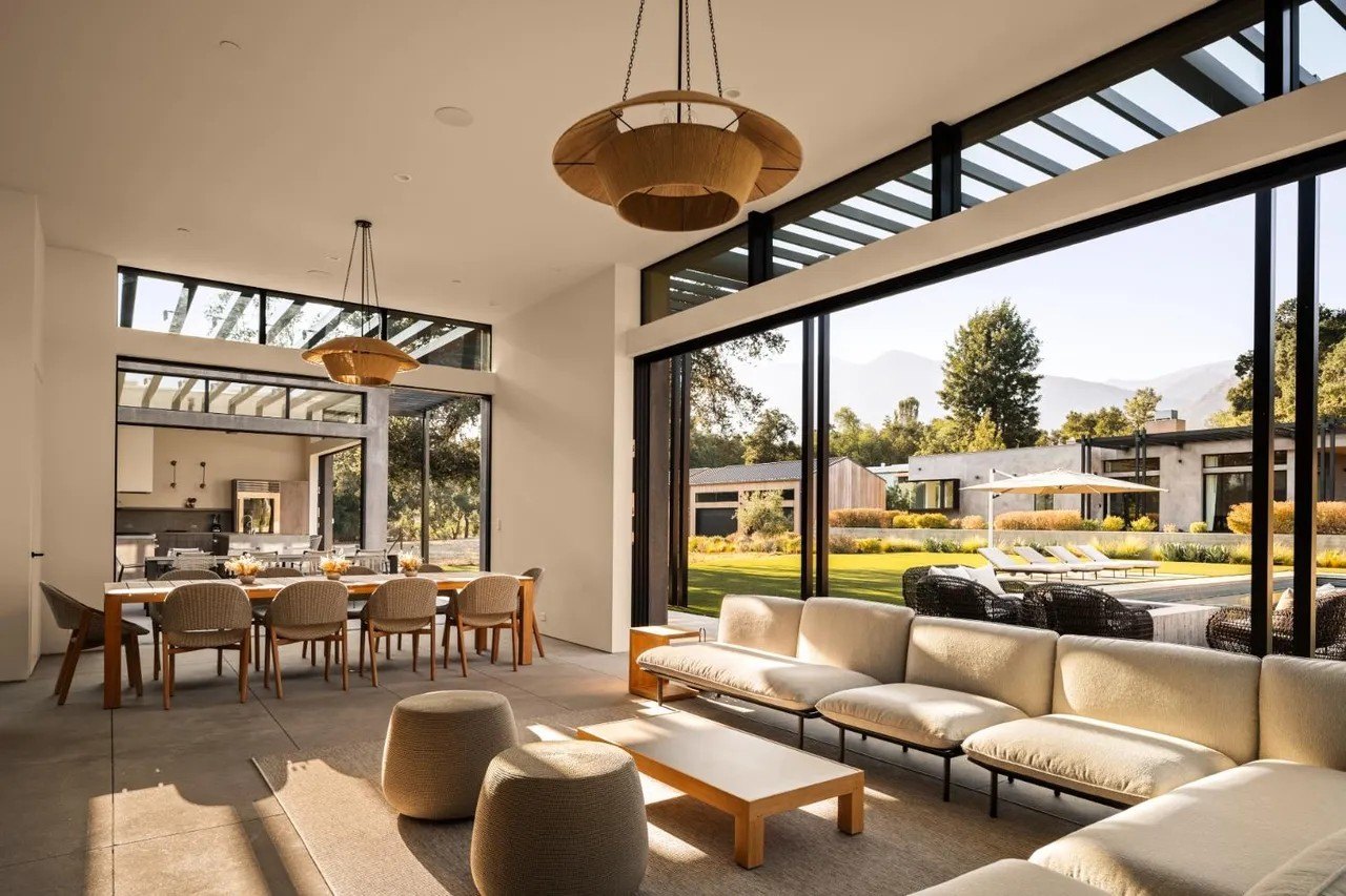 This stunning pool pavilion exemplifies how all spaces are extremely generous, and have floor-to-ceiling windows and doors of glass that lead to the ultimate indoor/outdoor experience.