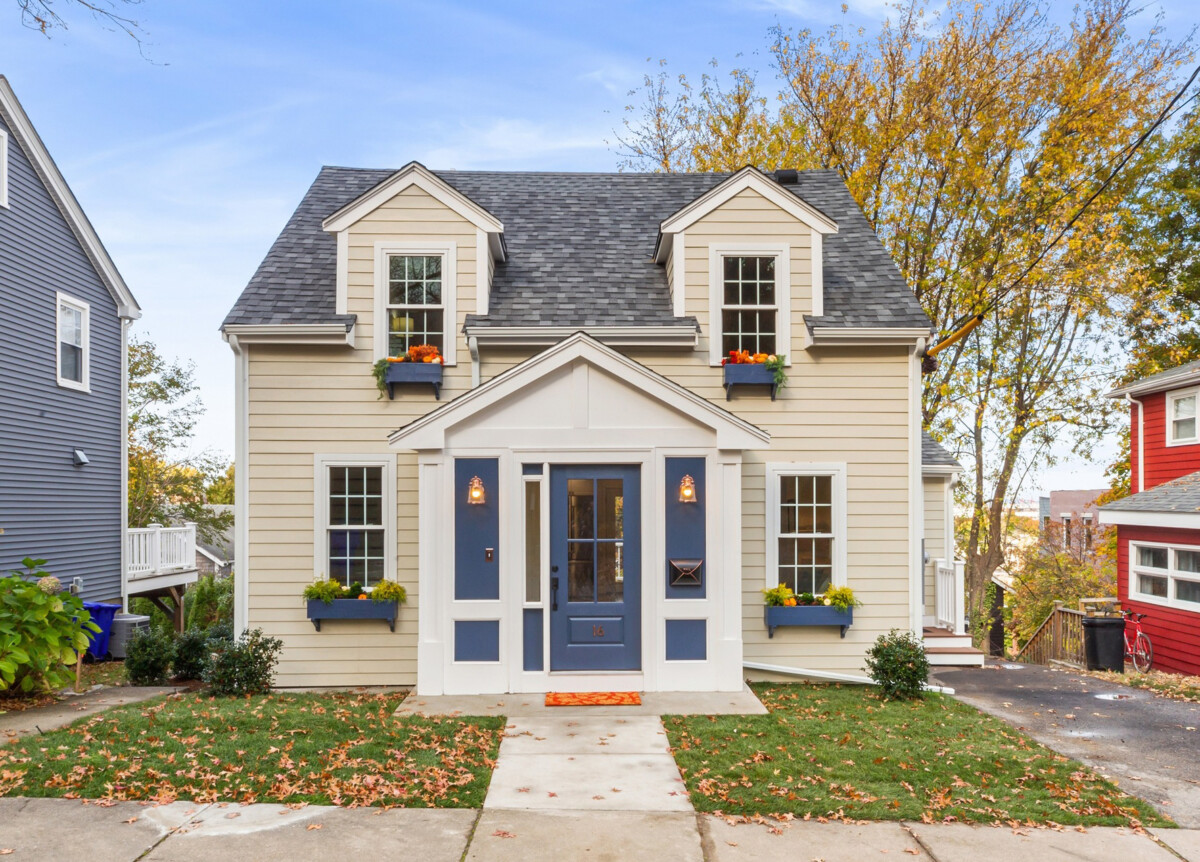 home with blue doors and tan exterior