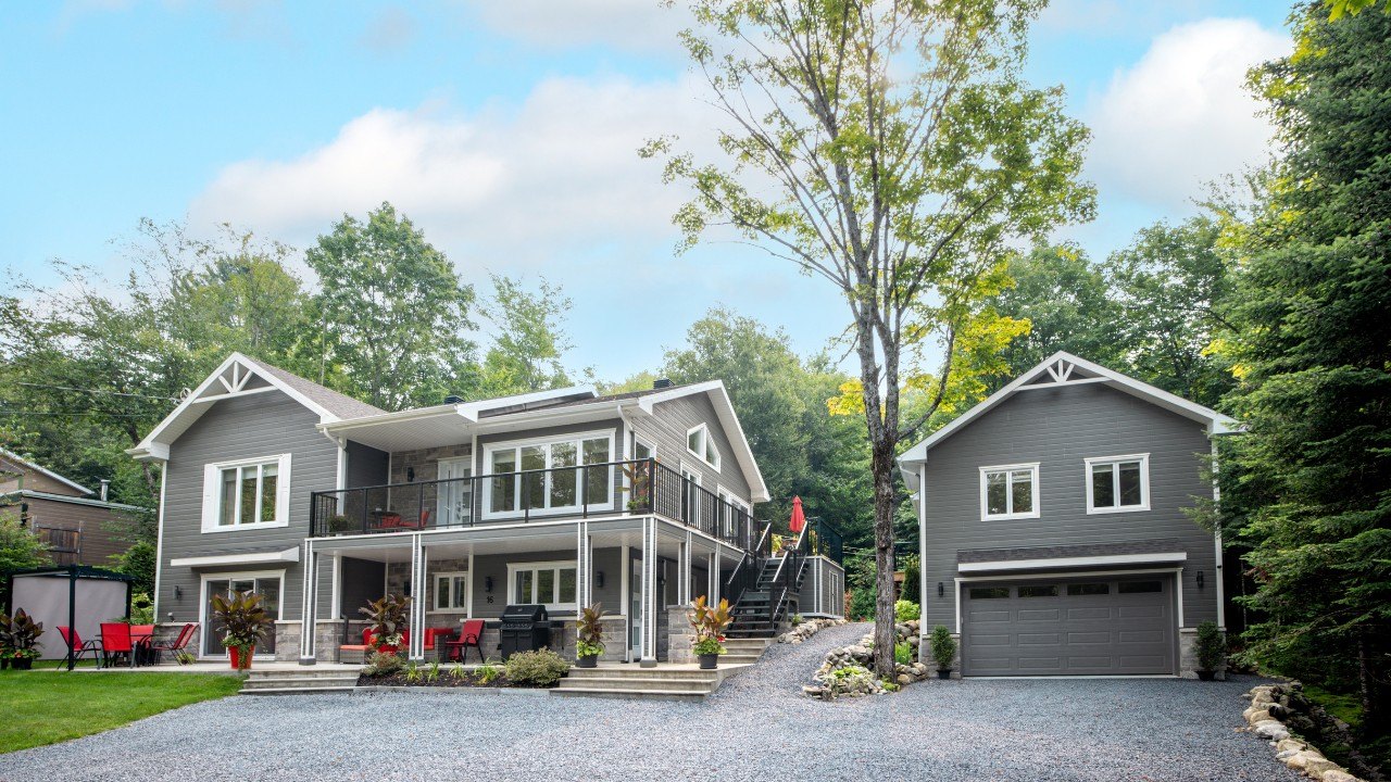 A modern home with two porches, a patio, and garage.