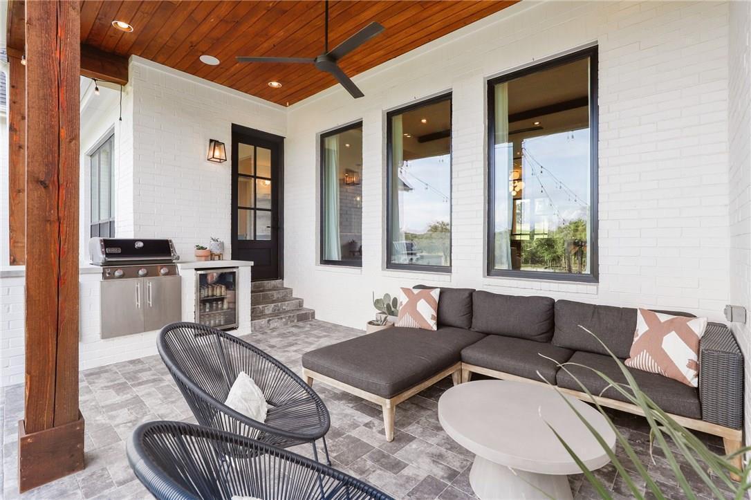 small outdoor kitchen with outdoor seating