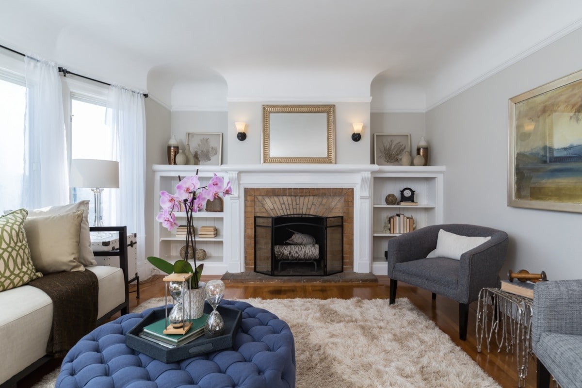 A living room with a brick fireplace as the focal point