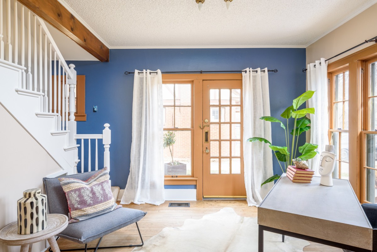 entryway of a home with desk and chair with a blue painted wall