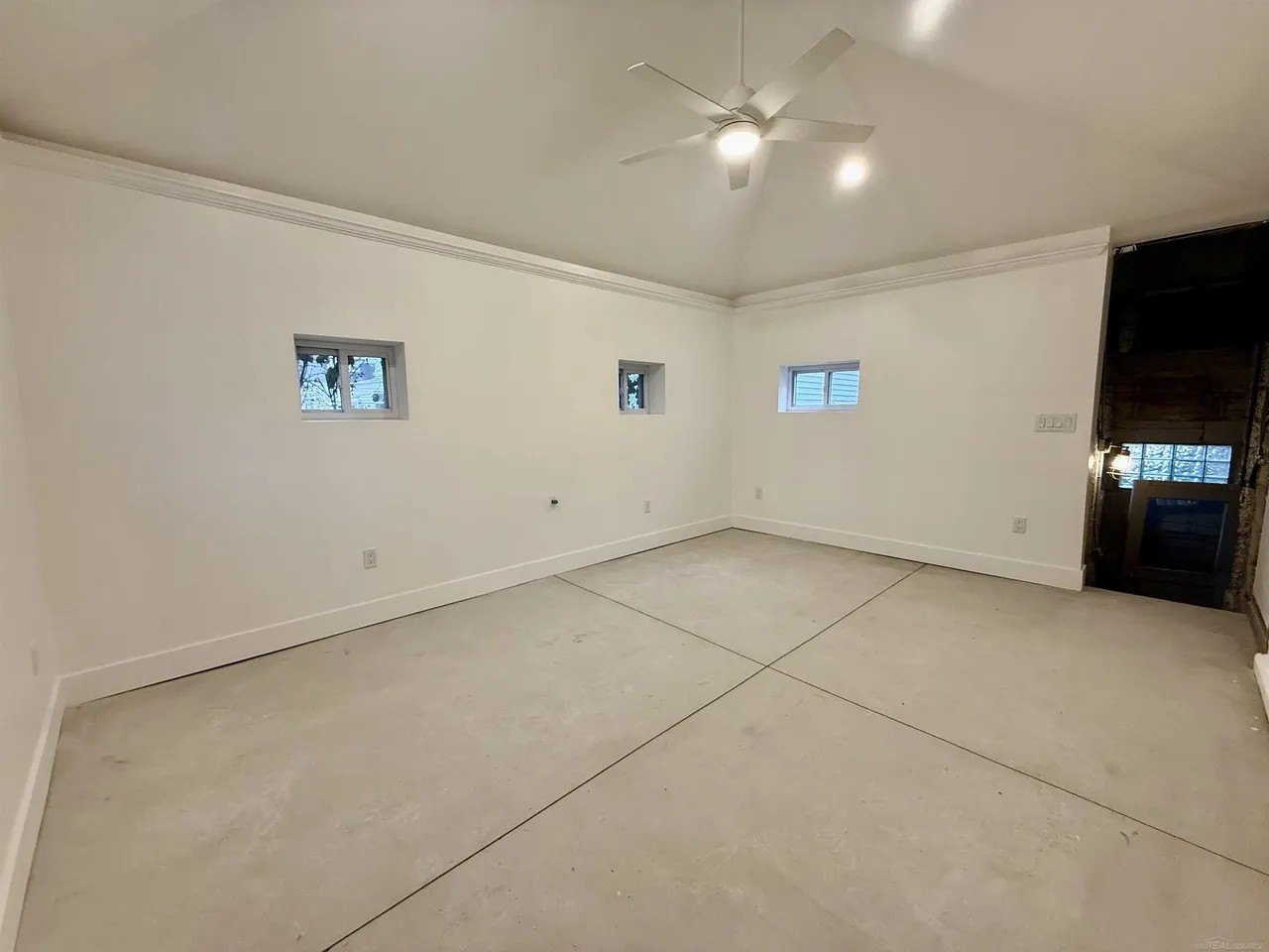 At some point a sizable room with an unusual entry was added to the back of the house. Schiller added a tray ceiling.