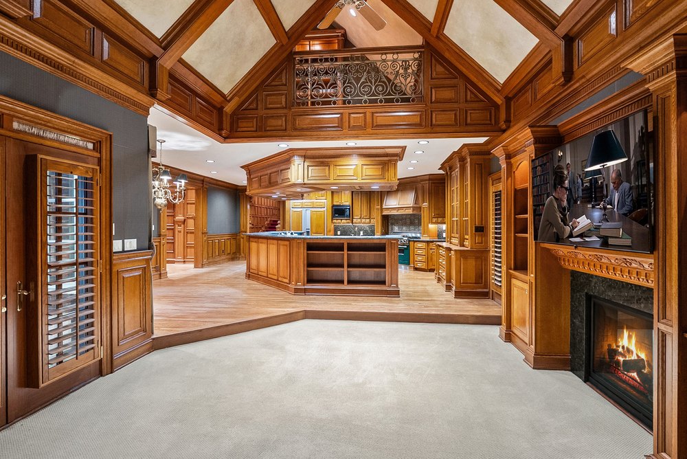 Open-Concept Kitchen and Family Room Area with Vaulted Ceiling and Fireplace