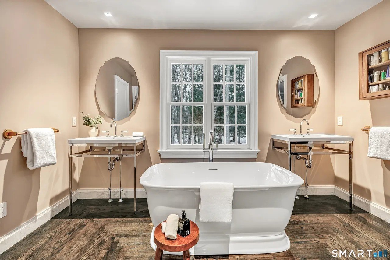 A large soaking tub and two sinks in a bathroom in Paige Lorenze Connecticut home