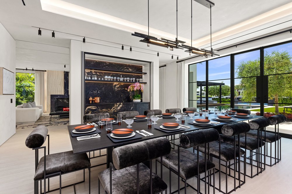 Formal Modern Dining Room with Long Table, Velvet Chairs, and Marble Wet Bar