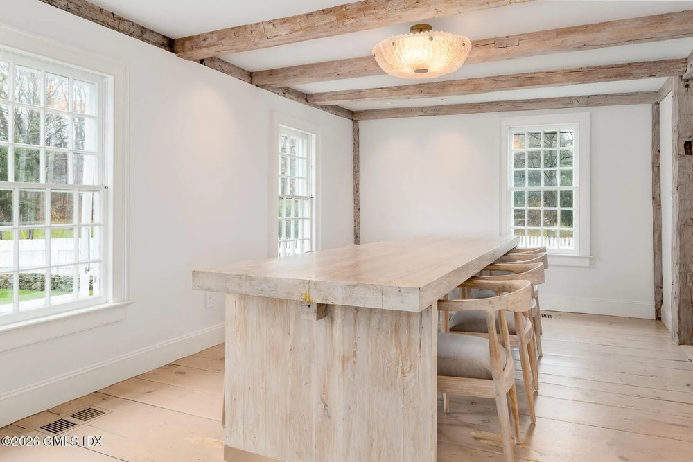 A wooden table with chairs in Chris Simms equestrian estate in Greenwich Connecticut