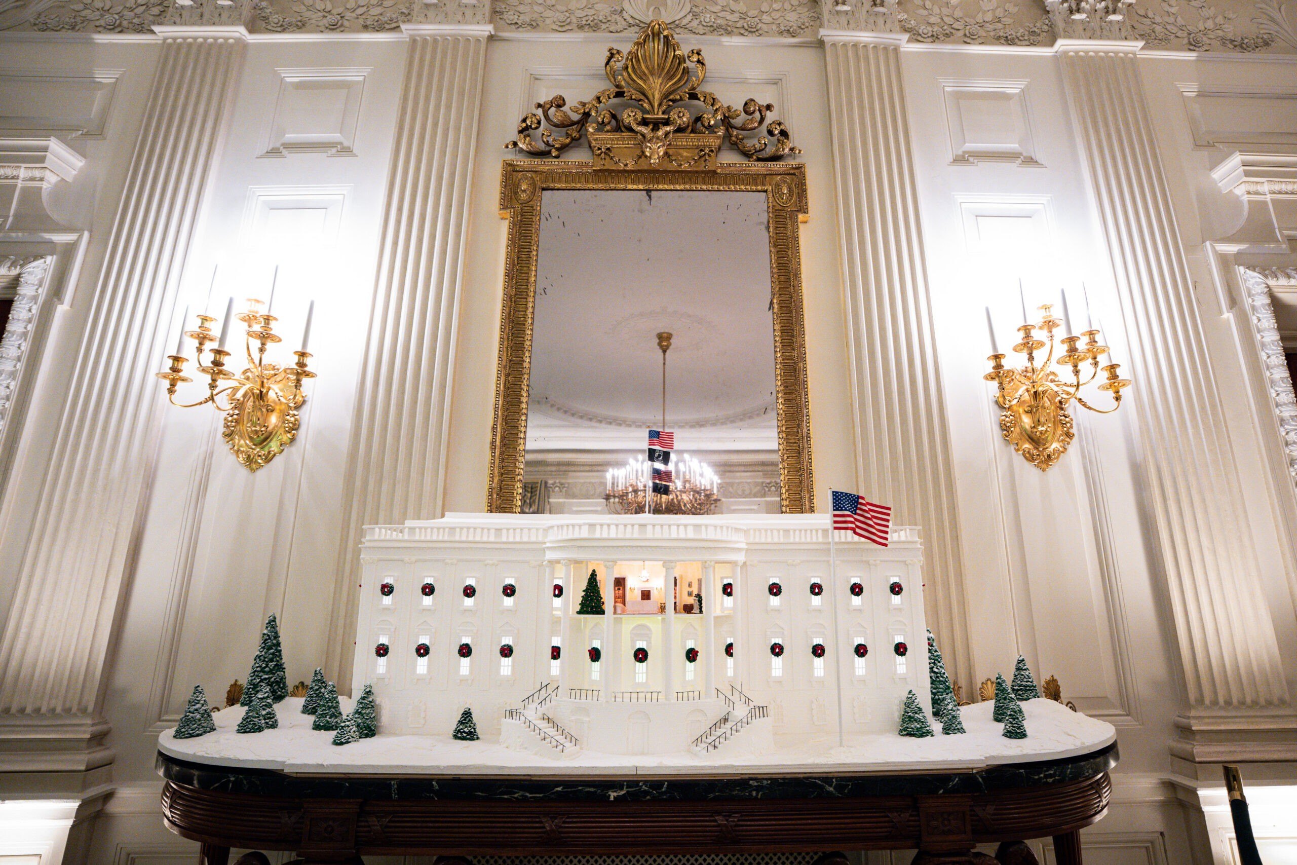 A gingerbread house with a cutout of the Yellow Oval Room in the private residence displayed in the State Dining Room of the White House during a media tour of the White House Christmas decorations in Washington, DC, US, on Monday, Dec. 1, 2025. The theme of the 2025 White House Christmas decorations is "Home Is Where The Heart Is." Photographer: Al Drago/Bloomberg via Getty Images