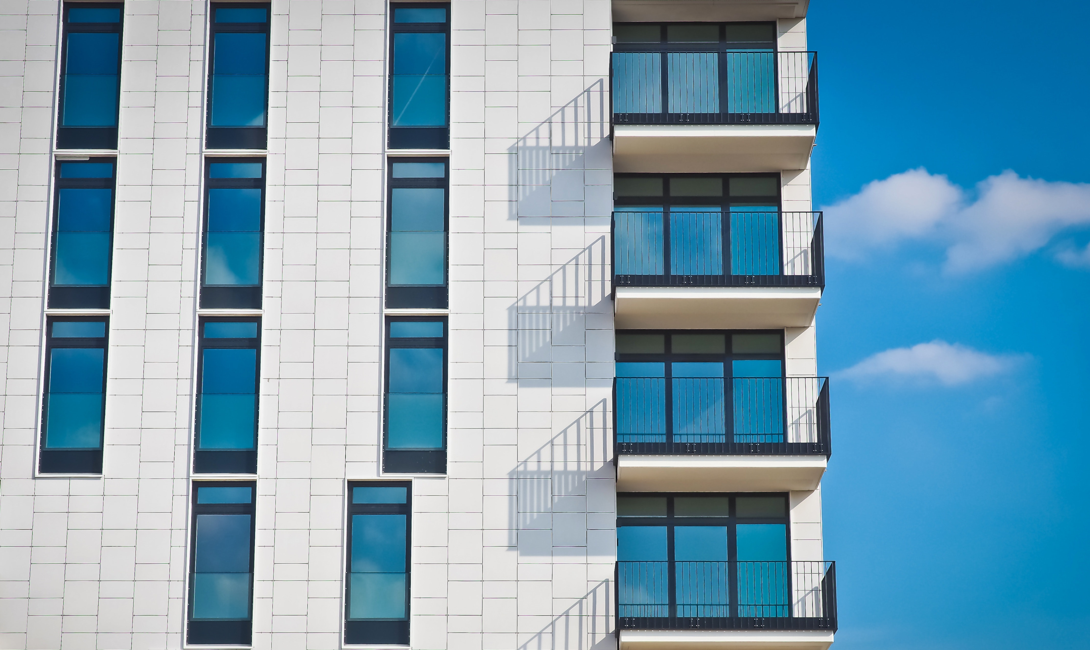 A modern apartment building with ceiling-to-floor windows