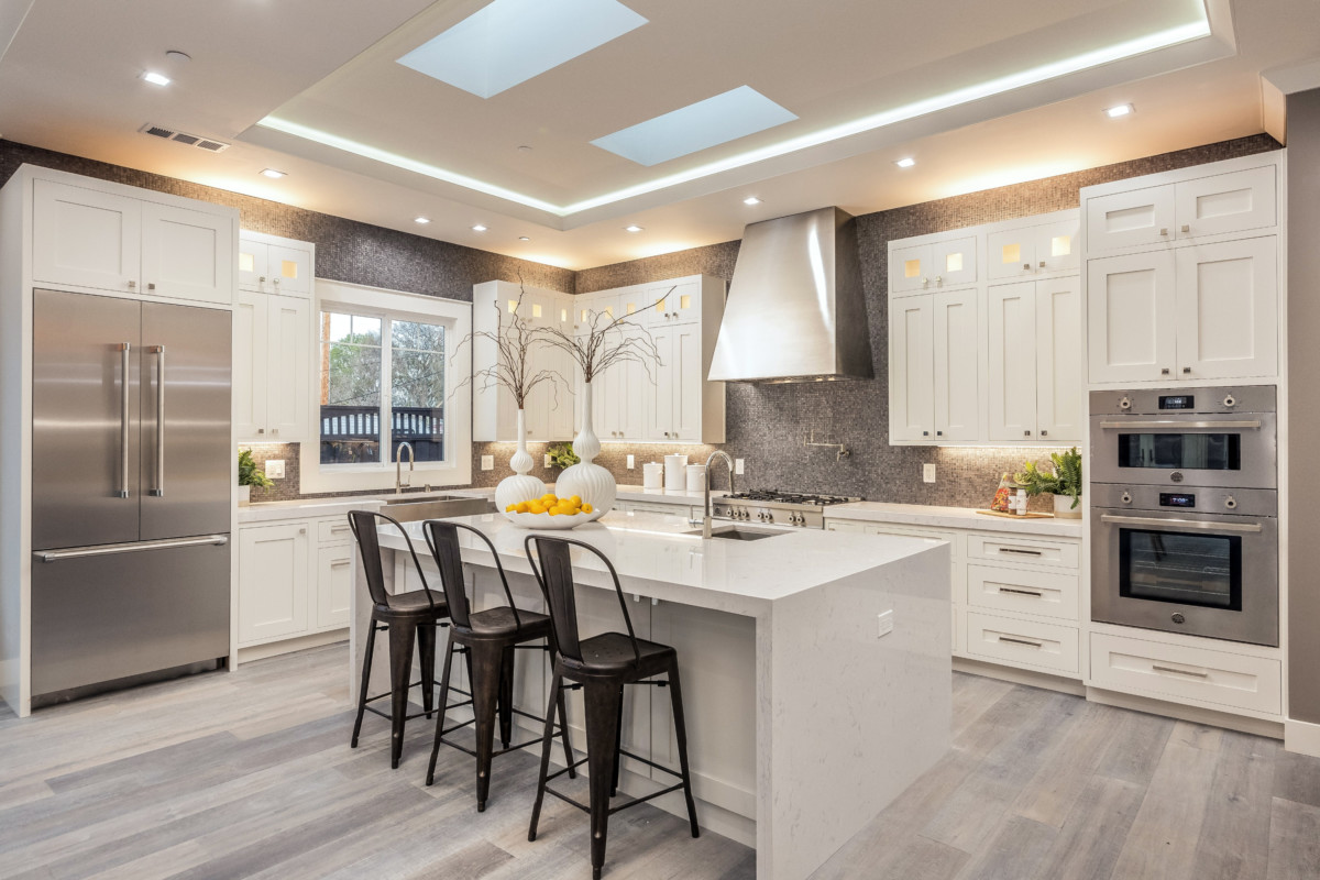 large kitchen with an island in the middle with open space