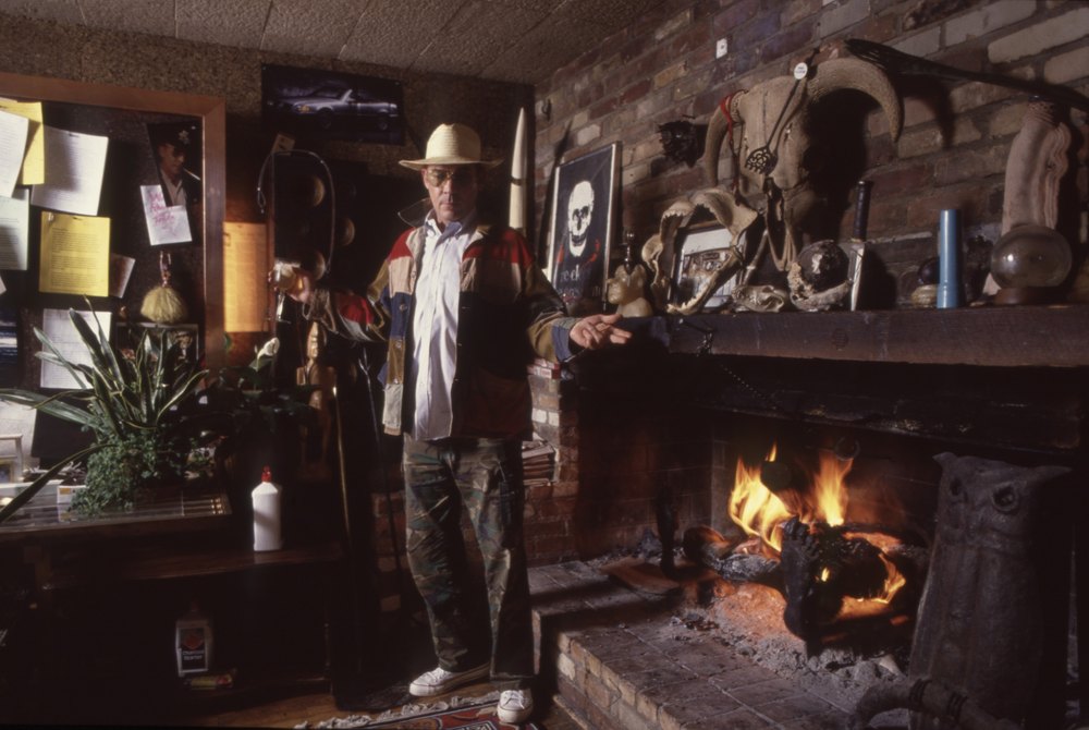 WOODY CREEK,ASPEN,CO, - OCTOBER 12: Hunter Thompson aka Hunter S Thompson aka Gonzo Journalist at his ranch standing next to his fireplace after adding logs to burn on October 12, 1990 in Woody Creek, Aspen, Colorado (Photo by Paul Harris/Getty Images)