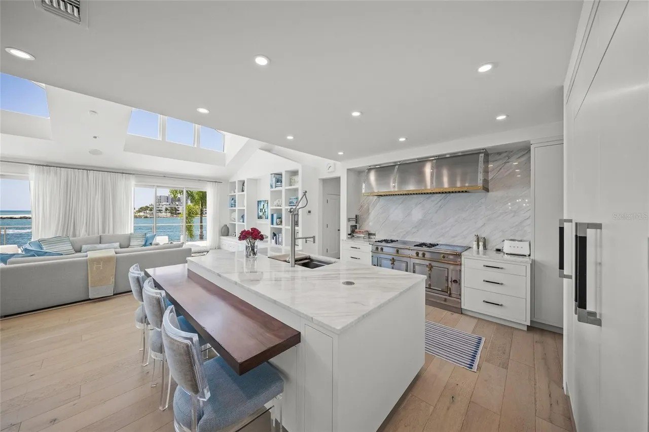 The kitchen is a designer chef's dream, with its Top of the line appliances, butler's pantry and sparkling dining/prep island.