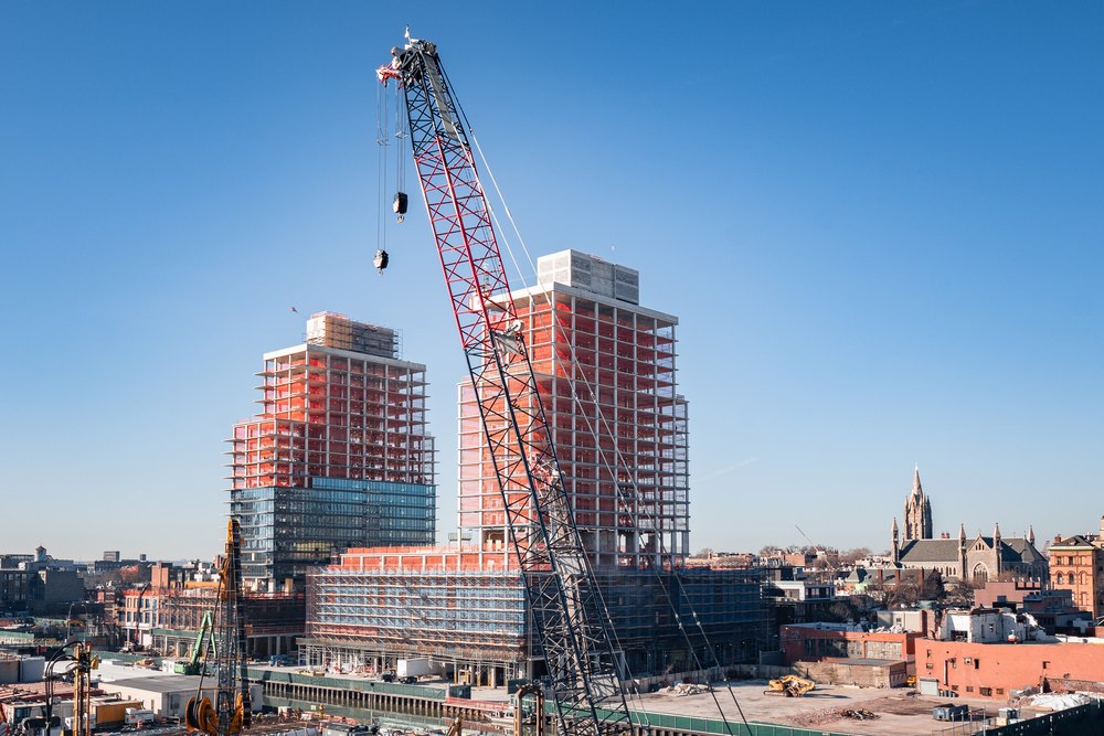 Construction site with new apartment buildings and cranes in Gowanus, Brooklyn, NY