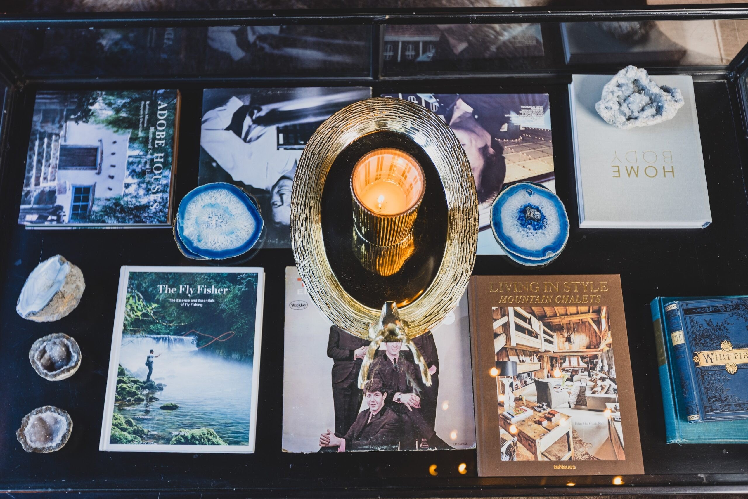 Items related to the couple's interests are displayed on a glass, industrial-style coffee table.