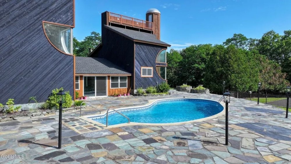 Pool area of midcentury home in Hague, NY, on sale for $995,000