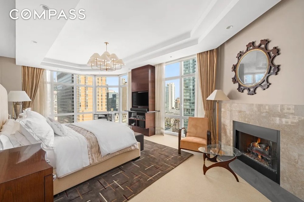 A bedroom with a fireplace in a luxury apartment in New York City that was in The Wolf of Wall Street starring Leonardo DiCaprio