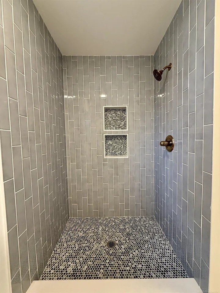 A new, walk-in shower with custom tile makes a big difference.