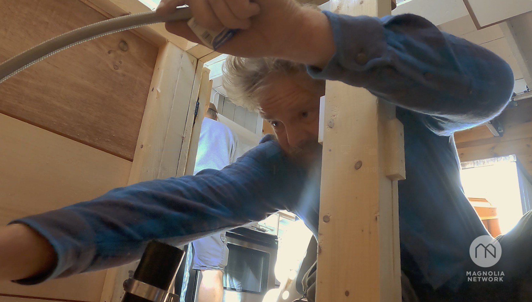 Morrill attempts to hook up the cabin's kitchen sink and install the kitchen countertop to complete the renovation.