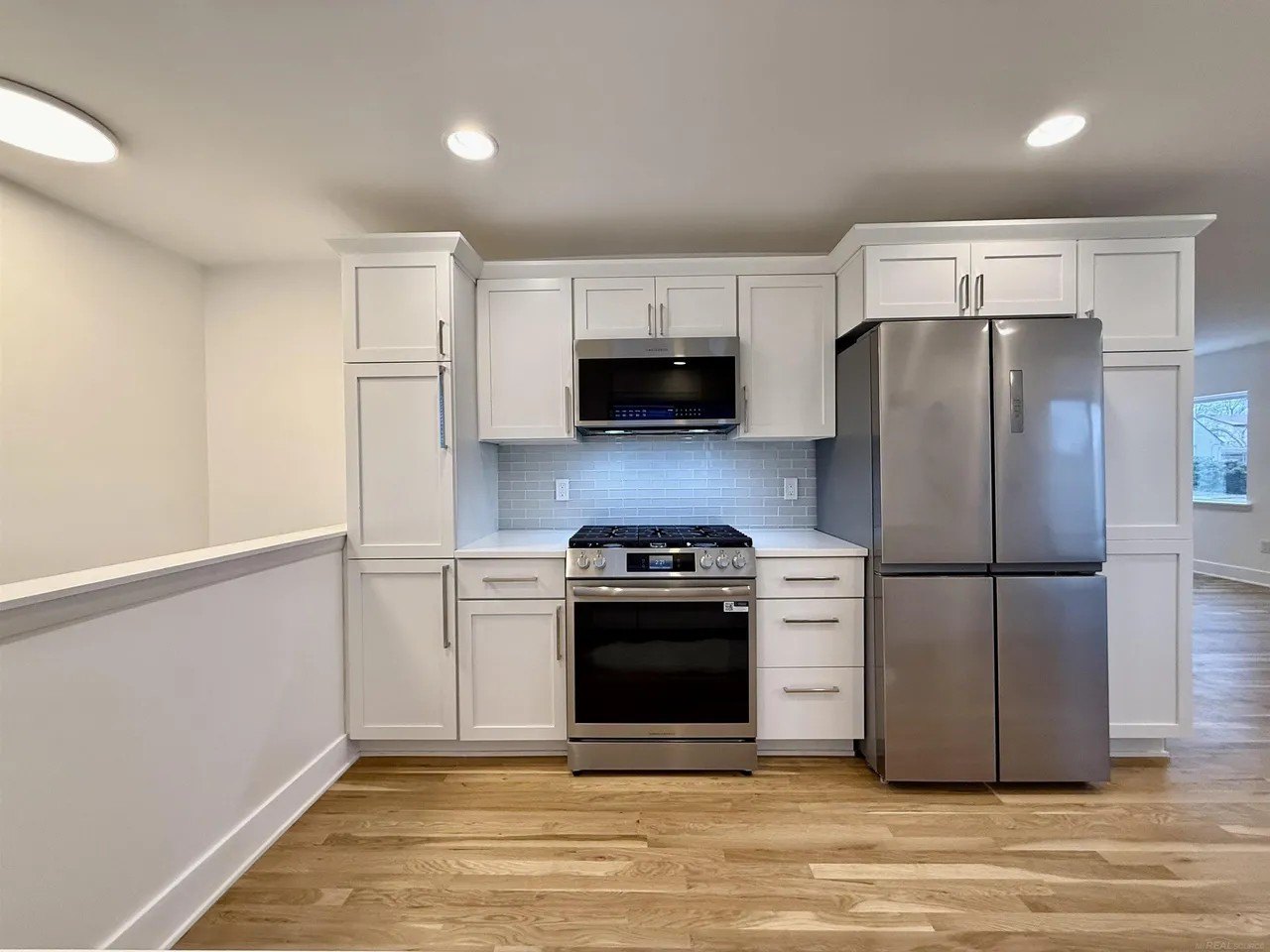 The new kitchen features granite countertops and white oak floors.