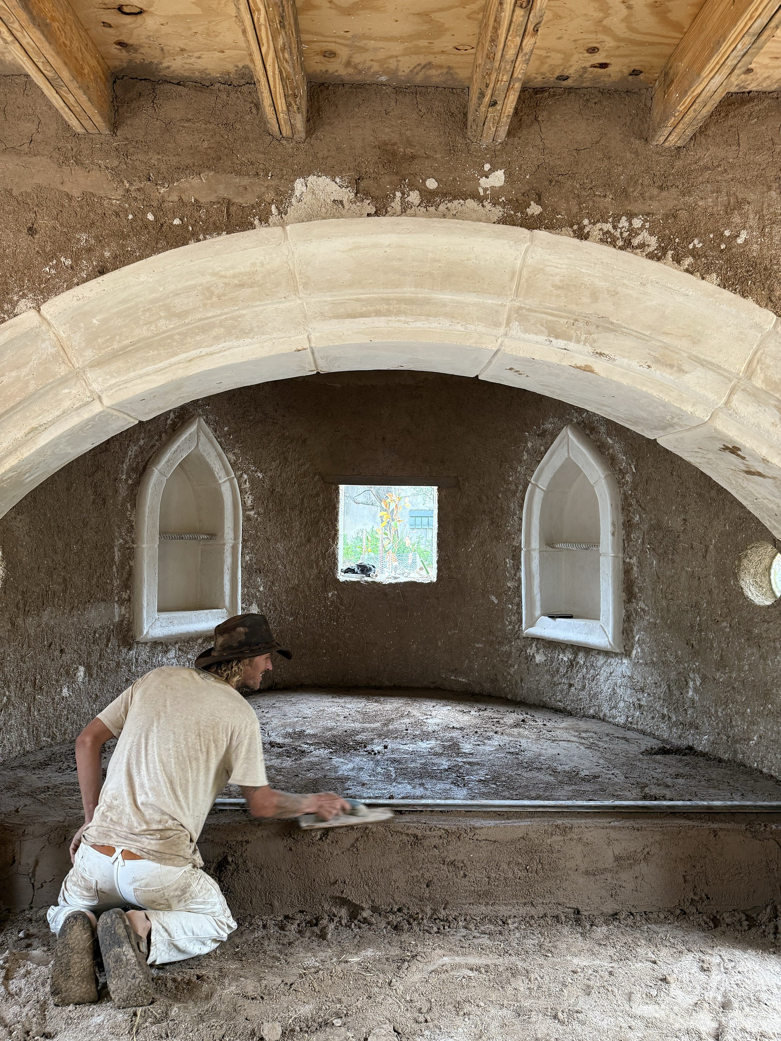 Dude Plastering an Interior Stone Archway
