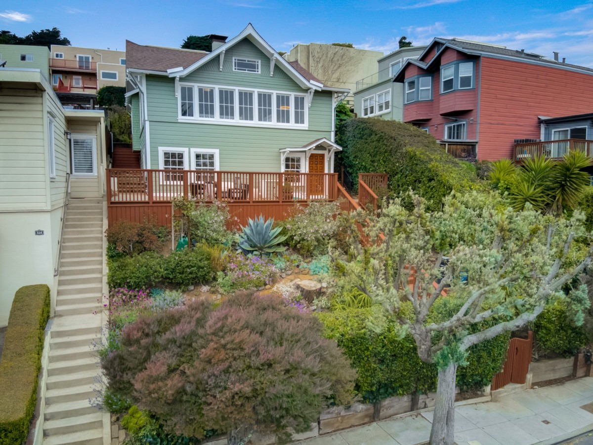 backyard-sage-colored-home-with-staircase-and-plants