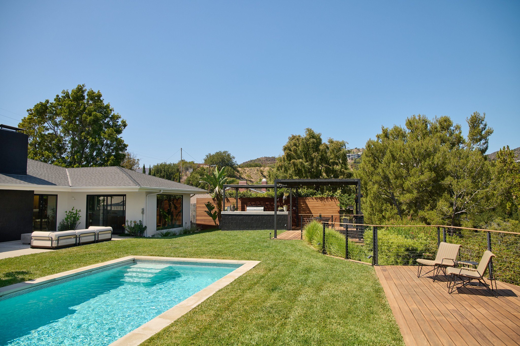 Backyard of LA home featuring pool and grassy area