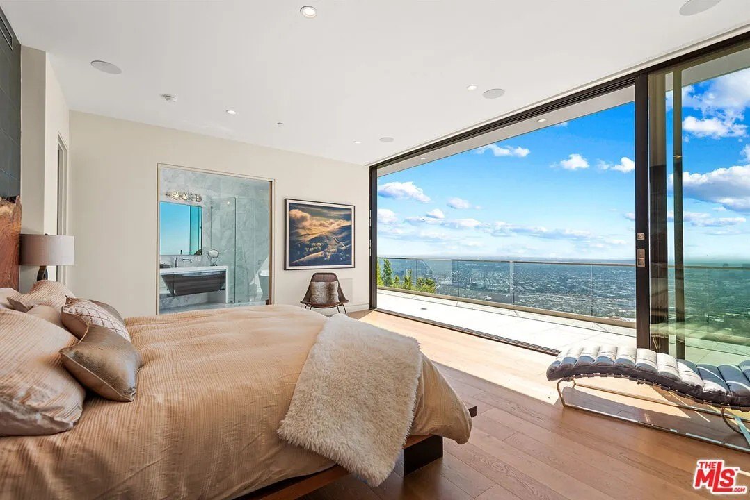 A bedroom with floor to ceiling sliding door windows in '50 Shades of Grey' Author EL James Los Angeles home