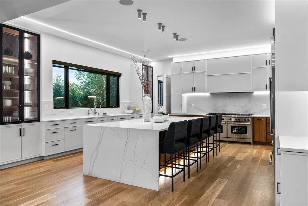 Kitchen with a large island and seating in a luxury home in Massachusetts that belongs to Jrue Holiday