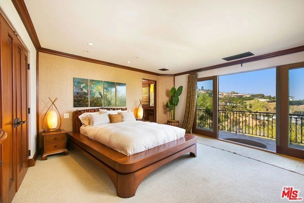 A bedroom with a balcony in a home on the land where sharon tate was murdered