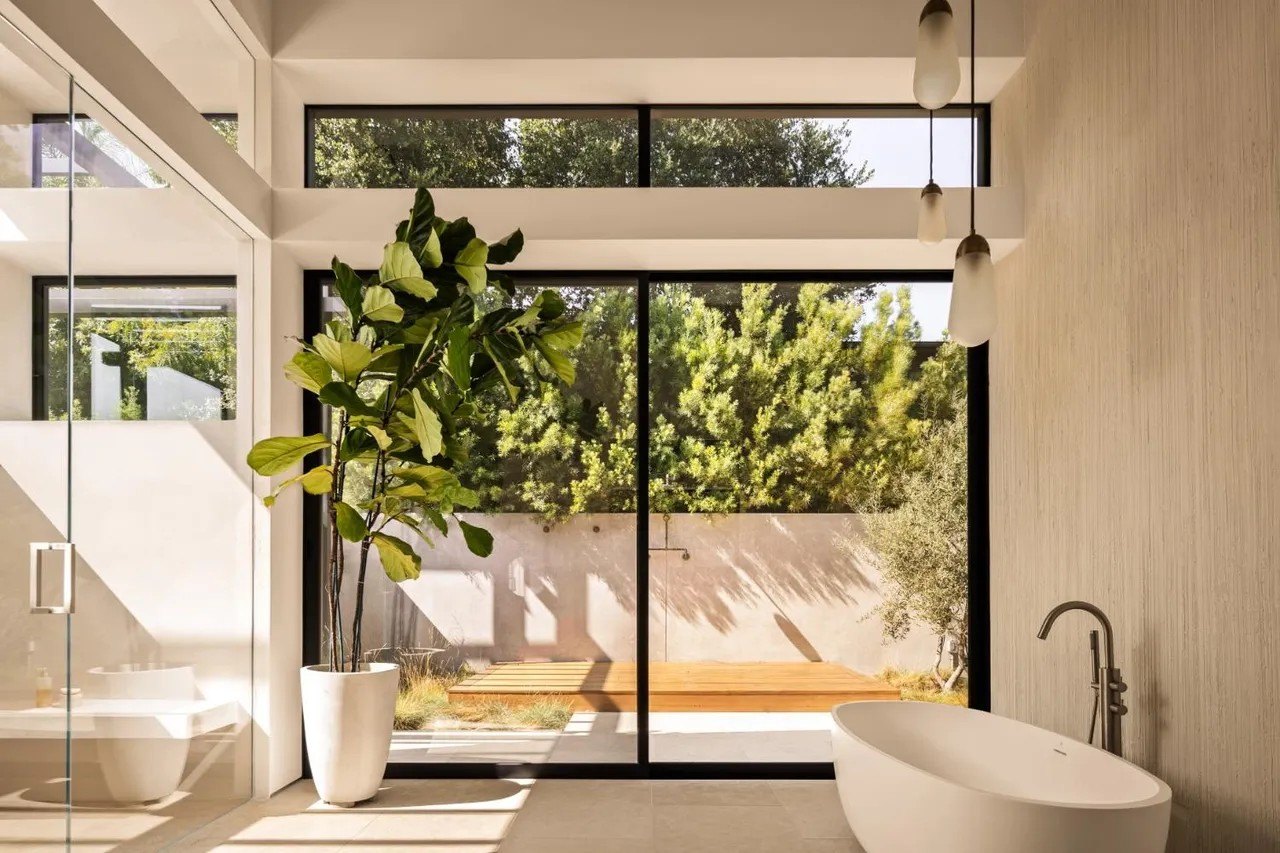 One of the primary suites features a boutique-inspired walk-in closet, a spa-like bathroom and an additional private outdoor shower and garden.