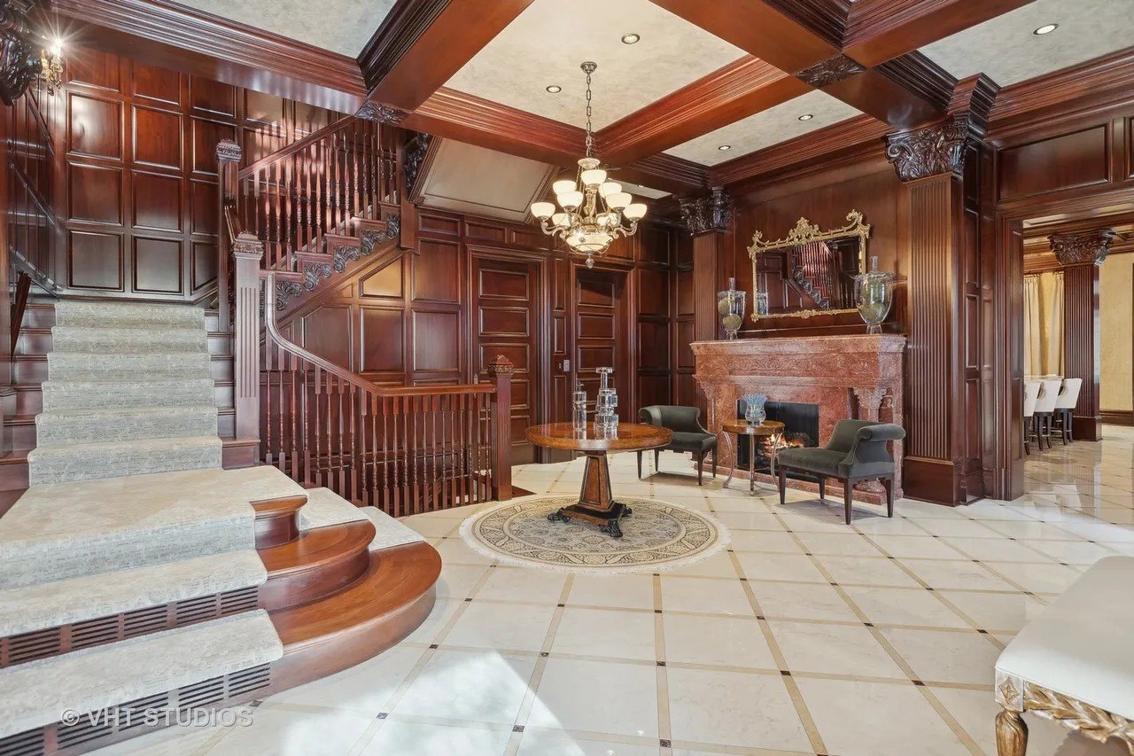 Among the beautifully restored original features are a mosaic floor, custom millwork, the hand-carved marble fireplaces from Italy, and the custom stained glass.