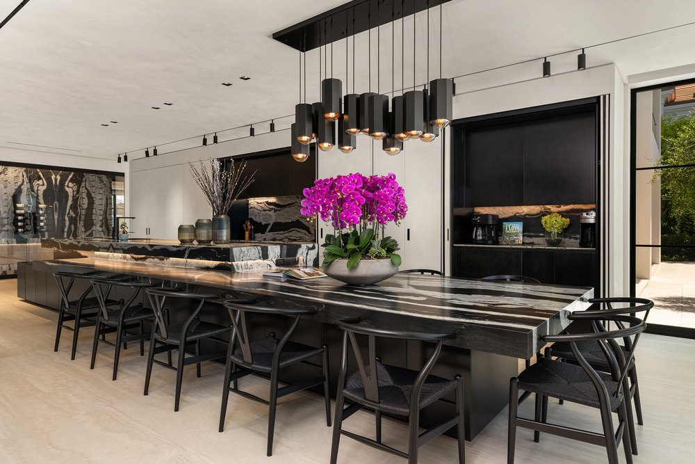Luxury Kitchen with Black Marble Waterfall Dining Island and Modern Chandelier