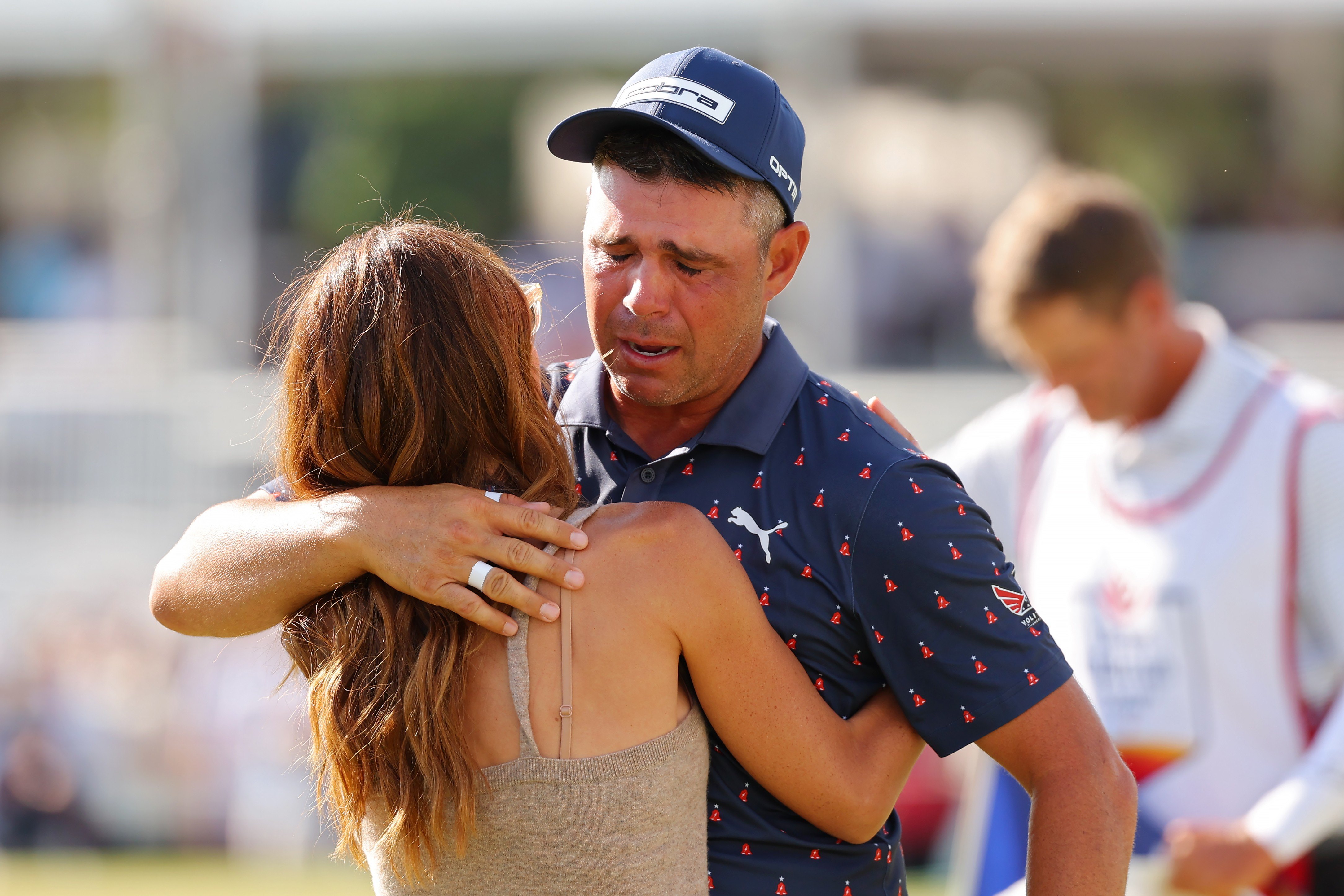 Gary Woodland of the United States embraces wife Gabby Granado on the 18th green after winning the Texas Children's Houston Open 2026 at Memorial Park Golf Course on March 29, 2026 in Houston, Texas