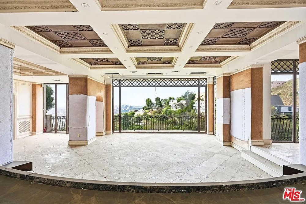 A Graffiti-Covered Mansion Is Back on the Market with a Starting Bid of $2.2 Million Grand Open Living Space with Coffered Ceiling and Panoramic View Windows