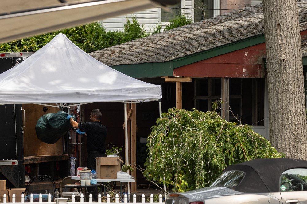 Crime laboratory officers search the home of Gilgo Beach murders suspect Rex Heuermann in Massapequa Park New York