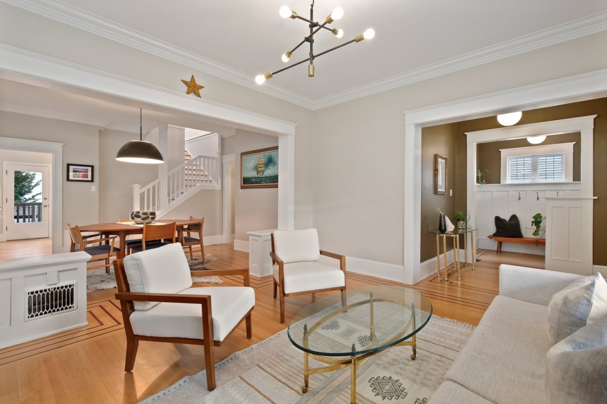 A living room designed with contemporary clean lines and shapes varying in gold to gray accents