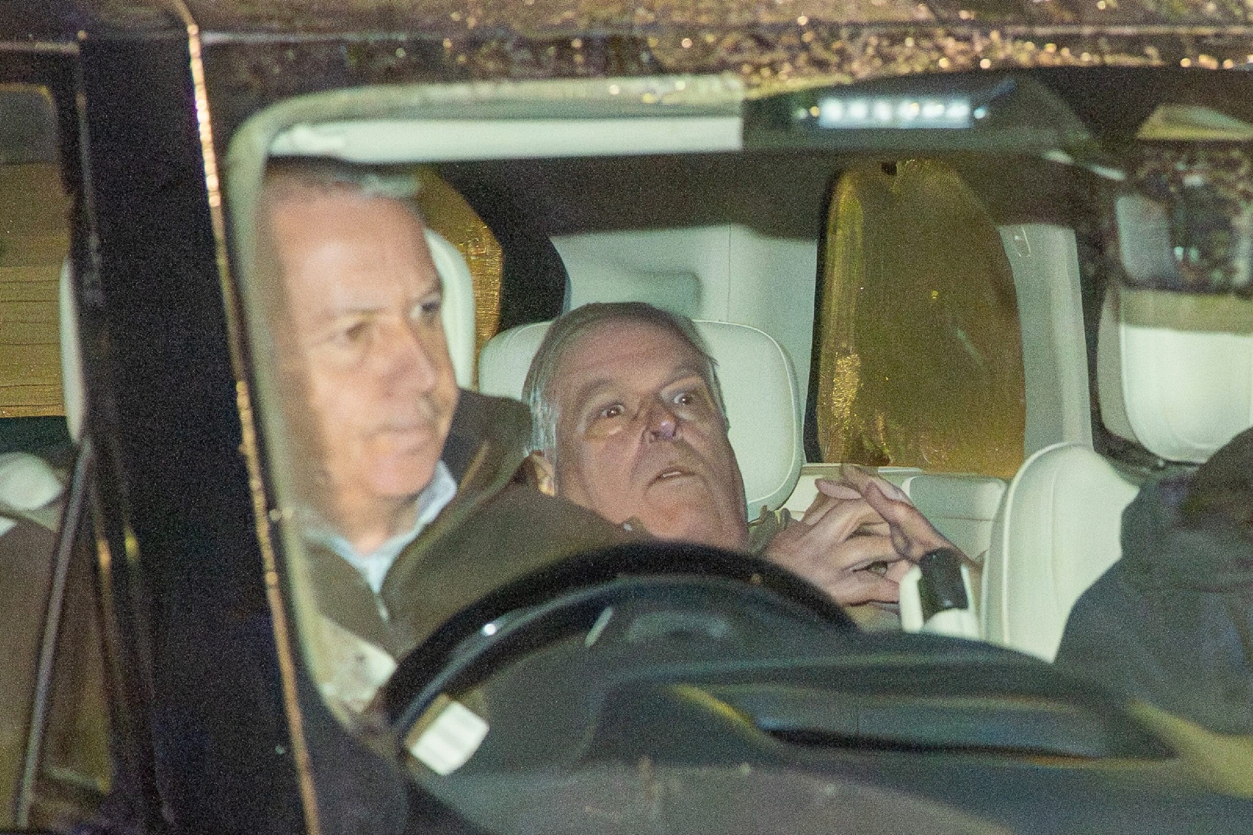 Andrew Mountbatten-Windsor is seen being driven away from a police station following his arrest on suspicion of misconduct in a public office