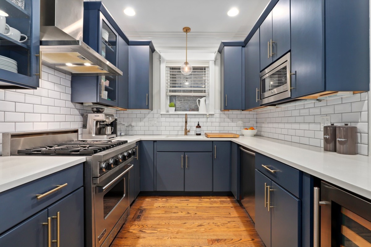 u-shaped kitchen in a small room with lots of cabinets