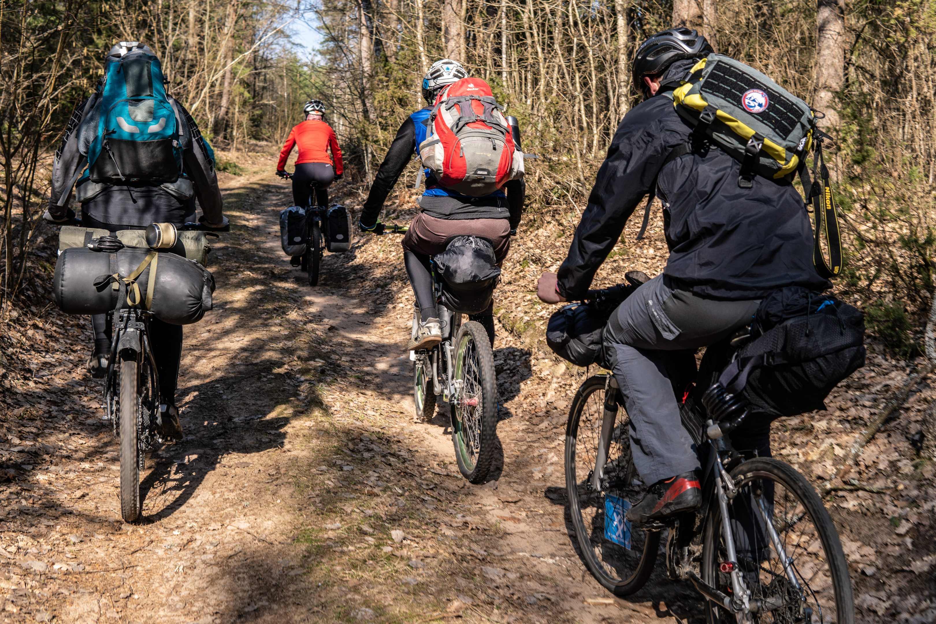 People riding bicycles on a dirt road