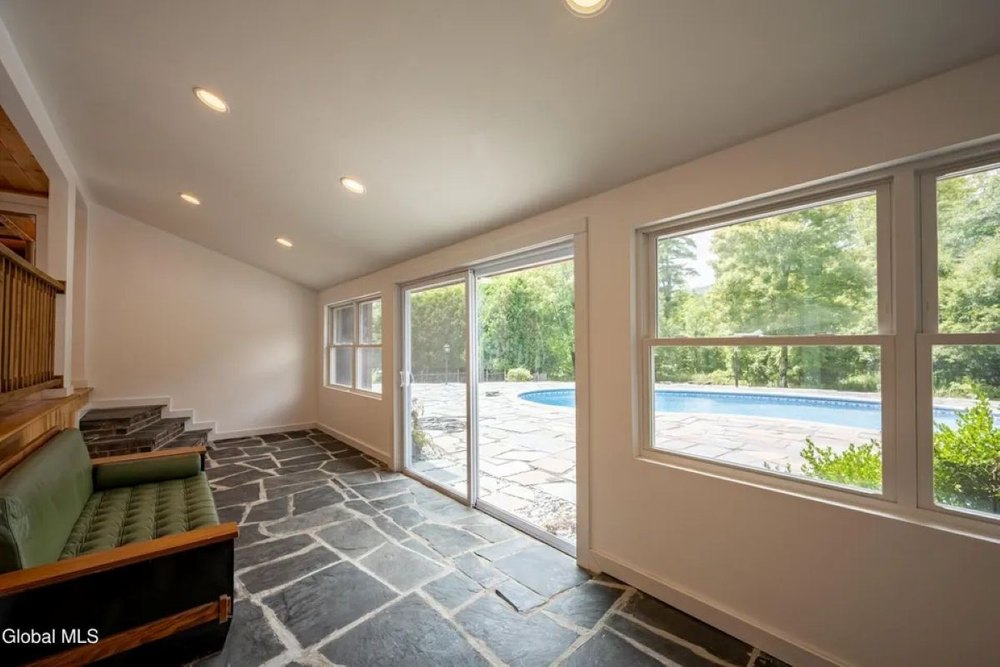 Sunroom of midcentury home in Hague, NY, on sale for $995,000
