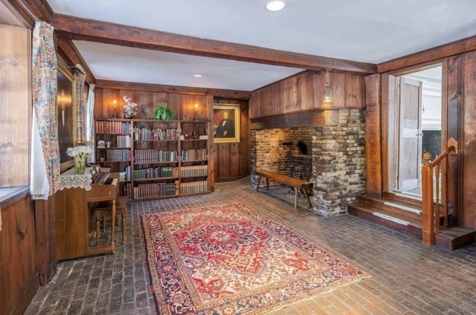 A view of a wood-panelled library inside historic Cambridge, MA, home
